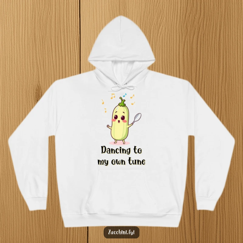 Surprised zucchini sprouting musical notes while dancing with a spoon, a musical and humorous hoodie.