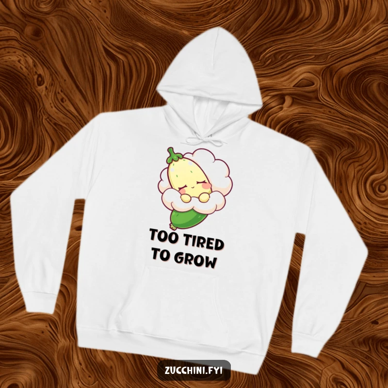 Funny sleepy zucchini hoodie showing a drowsy zucchini gently carried by a fluffy cloud, offering warmth and humorous dreams.