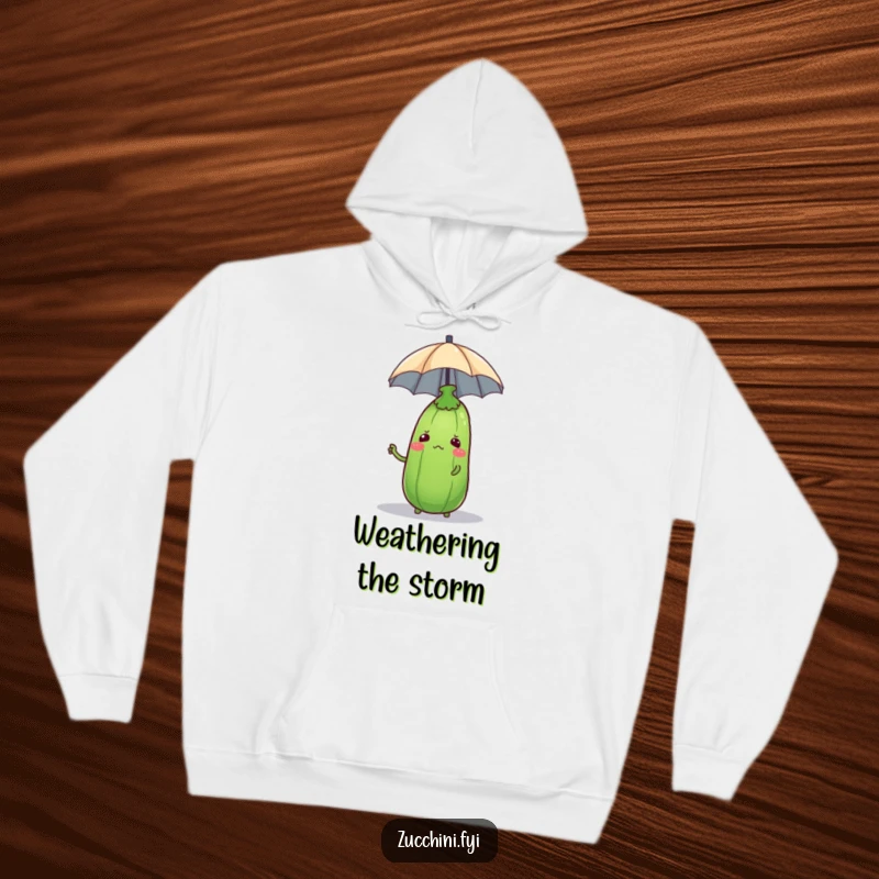 Soft hoodie featuring a confused zucchini attempting to balance a small umbrella on its head, providing warmth and humor.