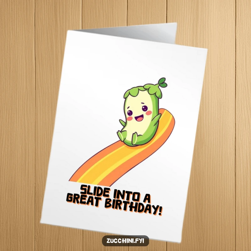 Funny free printable birthday card: a smiling zucchini slides down a vibrant rainbow, spreading joy and good vibes.